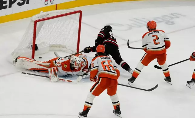 Chicago Blackhawks center Connor Bedard (98) scores a goal on Anaheim Ducks goalie Ville Husso (33) during the third period of an NHL hockey game Sunday, Nov. 30, 2025, in Chicago. (AP Photo/David Banks)