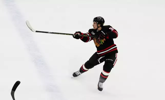 Chicago Blackhawks center Connor Bedard scores an empty net goal against the Anaheim Ducks during the third period of an NHL hockey game, Sunday, Nov. 30, 2025, in Chicago. (AP Photo/David Banks)