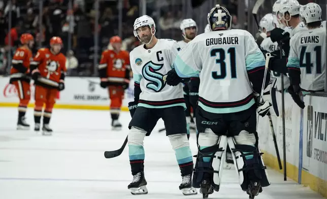 Seattle Kraken right wing Jordan Eberle (7) celebrates his goal with goaltender Philipp Grubauer (31) during the third period of an NHL hockey game against the Anaheim Ducks, Monday, Dec. 22, 2025, in Anaheim, Calif. (AP Photo/Kyusung Gong)