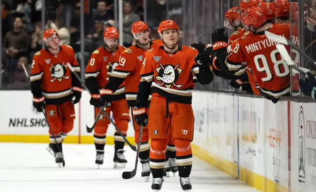 Anaheim Ducks center Mikael Granlund, center, celebrates with the bench after his goal during the second period of an NHL hockey game against the Seattle Kraken, Monday, Dec. 22, 2025, in Anaheim, Calif. (AP Photo/Kyusung Gong)
