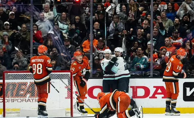 Seattle Kraken right wing Jordan Eberle (7) celebrates his goal with center Matty Beniers (10) during the third period of an NHL hockey game against the Anaheim Ducks, Monday, Dec. 22, 2025, in Anaheim, Calif. (AP Photo/Kyusung Gong)