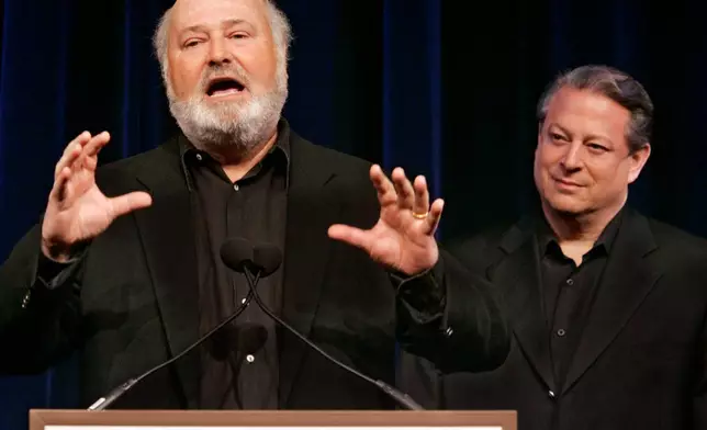 FILE - Former Vice President AL Gore, right, listens as movie director Rob Reiner addresses a Tribeca Film Festival news conference on a series of global warming-themed short films produced by the SOS (Save Our Selves) campaign which opened the festival in a gala hosted by Gore, April 25, 2007, in New York. (AP Photo/Richard Drew, File)