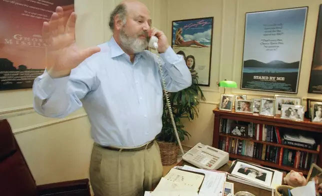 FILE - Rob Reiner talks on the phone at his office at Castle Rock Enterprises, seeking donations for anti-smoking campaigns, July 29, 1988, in Beverly Hills, Calif. (AP Photo/Reed Saxon, File)