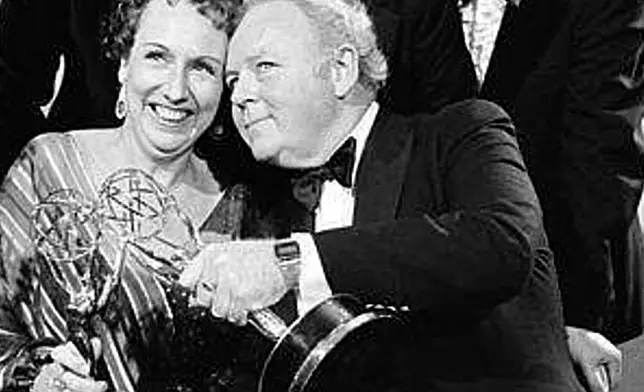 FILE - Actors Jean Stapleton, seated, left, and Carroll O'Connor, seated, right, hold their Emmys after receiving them in Los Angeles, Sept. 18, 1978. At rear, from left, Rob Reiner, who won an Emmy for supporting actor in the same series; Norman Lear, producer of the show; and executive producer Mort Lachman. (AP Photo/David Yarnold, File)