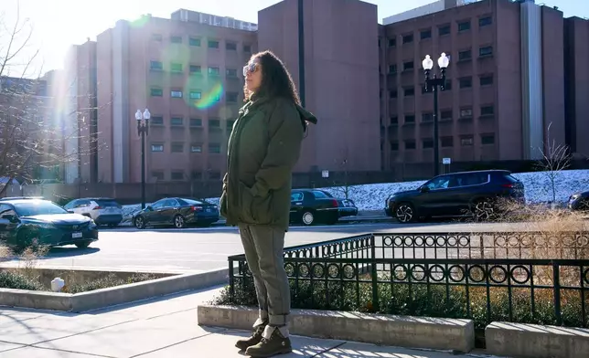 Sidney Reid, 44, of Washington, poses for a portrait near where she was arrested while protesting immigration detentions, Tuesday, Dec. 16, 2025, in Washington. (AP Photo/Jacquelyn Martin)