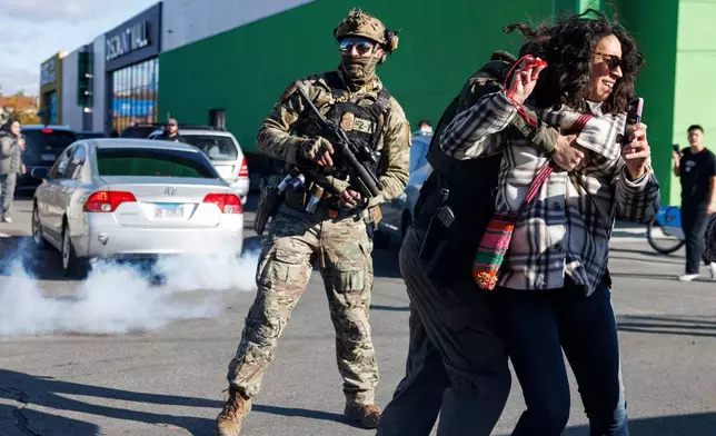 FILE - Federal immigration enforcement agents detain a protester in the Little Village neighborhood of Chicago on Thursday, Oct. 23, 2025. (Anthony Vazquez/Chicago Sun-Times via AP, File)