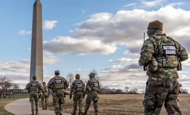 FILE - National Guardsmen patrol in front of the Washington Monument on the National Mall, Friday, Nov. 28, 2025, in Washington. (AP Photo/Julia Demaree Nikhinson, File)