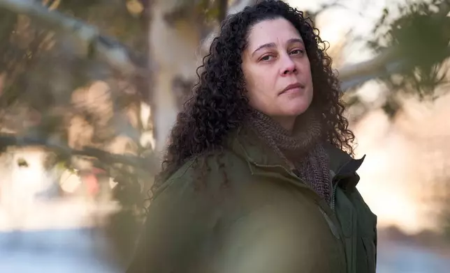 Sidney Reid, 44, of Washington, poses for a portrait near where she was arrested while protesting immigration detentions, Tuesday, Dec. 16, 2025, in Washington. (AP Photo/Jacquelyn Martin)