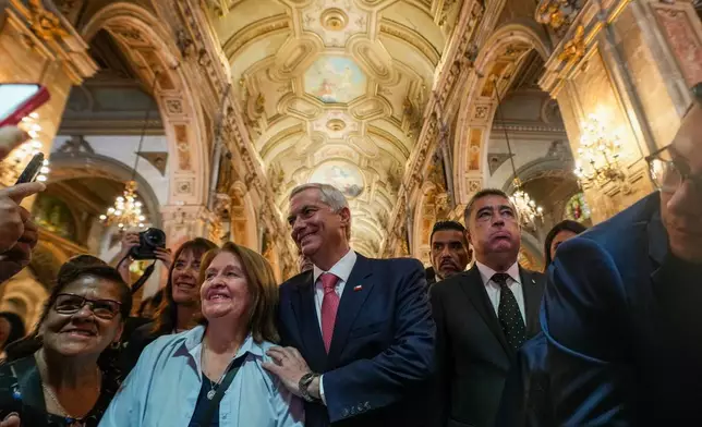 Chilean President-elect Jose Antonio Kast and his wife Maria Pia Adriasola greet supporters at the Santiago Cathedral after attending Mass in Santiago, Chile, Friday, Dec. 19, 2025. (AP Photo/Esteban Felix)