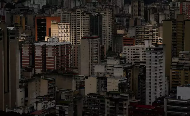 Buildings stand in Caracas, Venezuela, Tuesday morning, Dec. 23, 2025. (AP Photo/Matias Delacroix)