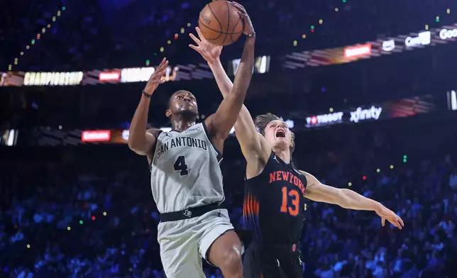 San Antonio Spurs guard De'Aaron Fox (4) shoots against New York Knicks guard Tyler Kolek (13) during the first half of the NBA Cup championship basketball game Tuesday, Dec. 16, 2025, in Las Vegas. (AP Photo/Ian Maule)