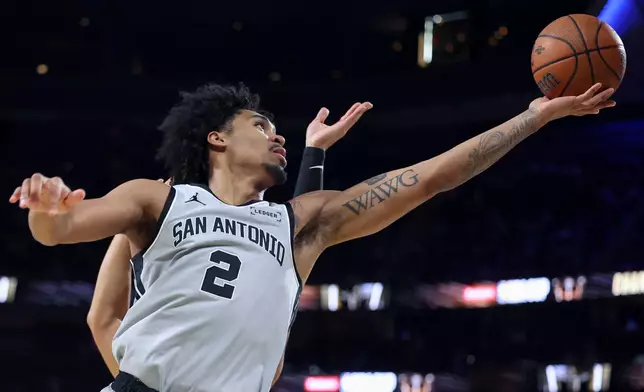 San Antonio Spurs guard Dylan Harper (2) shoots against the New York Knicks during the first half of the NBA Cup championship basketball game Tuesday, Dec. 16, 2025, in Las Vegas. (AP Photo/Ian Maule)