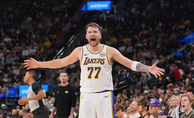 Los Angeles Lakers forward/guard Luka Doncic (77) reacts to a play during the first half of an NBA basketball game against the Los Angeles Clippers Saturday, Dec. 20, 2025, in Inglewood, Calif. (AP Photo/Jae C. Hong)