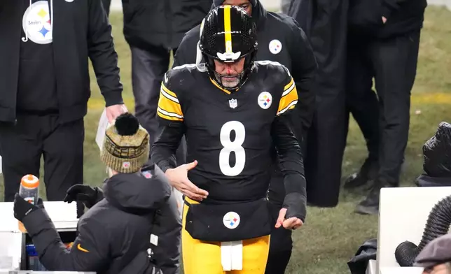 Pittsburgh Steelers quarterback Aaron Rodgers (8) walks to the sideline to be check out for injury during the second half of an NFL football game against the Buffalo Bills Sunday, Nov. 30, 2025, in Pittsburgh. (AP Photo/Gene J. Puskar)