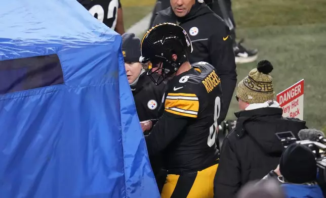 Pittsburgh Steelers quarterback Aaron Rodgers (8) walks to the sideline to be check out for injury during the second half of an NFL football game against the Buffalo Bills Sunday, Nov. 30, 2025, in Pittsburgh. (AP Photo/Gene J. Puskar)