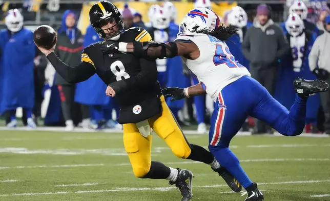 Pittsburgh Steelers quarterback Aaron Rodgers (8) throws against Buffalo Bills linebacker Dorian Williams (42) during the first half of an NFL football game Sunday, Nov. 30, 2025, in Pittsburgh. (AP Photo/Gene J. Puskar)