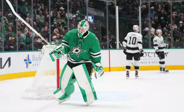 Dallas Stars goaltender Casey Desmith, left, skates away as Los Angeles Kings left wing Andrei Kuzmenko, far right, celebrates his second period goal with right wing Corey Perry (10) during an NHL hockey game Monday, Dec. 15, 2025, in Dallas. (AP Photo/Julio Cortez)