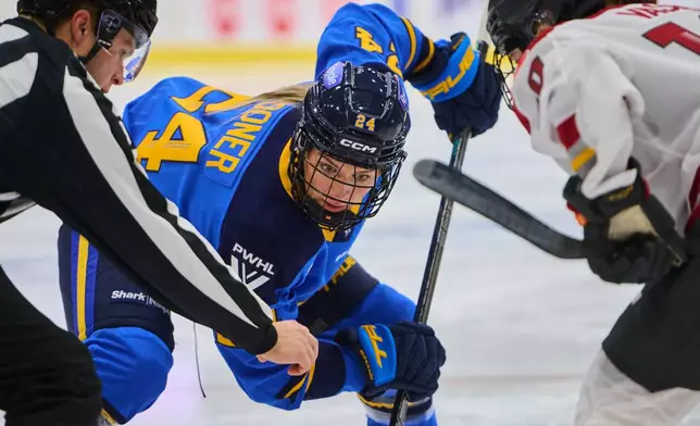 Toronto Sceptres' Natalie Spooner (24) faces off against Ottawa Charge's Alexa Vasko (10) during second period PWHL hockey action in Toronto, Tuesday, Dec. 23, 2025. (Sammy Kogan/The Canadian Press via AP)