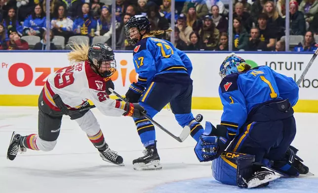 Ottawa Charge's Peyton Hemp (29) is stopped by Toronto Sceptres goaltender Raygan Kirk (1) as Ella Shelton (17) defends during the first period of a PWHL hockey game, in Toronto, Tuesday, Dec. 23, 2025. (Sammy Kogan/The Canadian Press via AP)