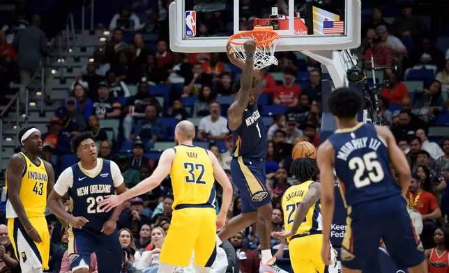 New Orleans Pelicans forward Zion Williamson (1) dunks against the Indiana Pacers during the first half of an NBA basketball game in New Orleans, Saturday, Dec. 20, 2025. (AP Photo/Matthew Hinton)
