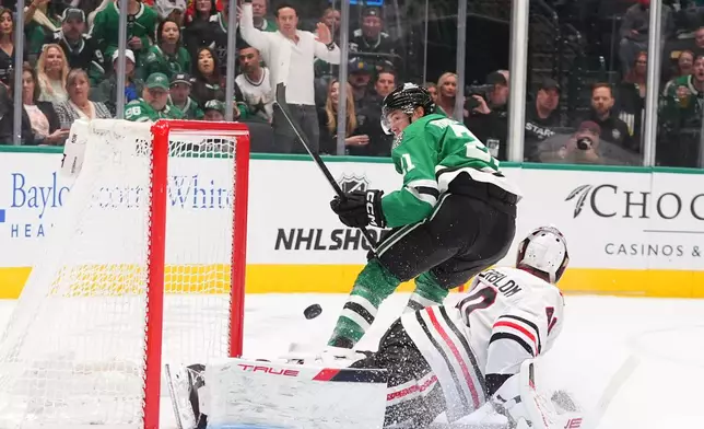 Chicago Blackhawks goaltender Arvid Soderblom (40) defends the goal against Dallas Stars left wing Jason Robertson (21) during the first period of an NHL hockey game Saturday, Dec. 27, 2025, in Dallas. (AP Photo/LM Otero)