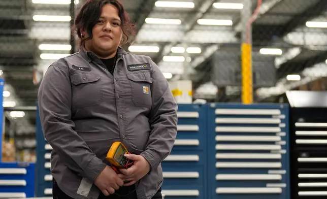 Maintenance technician Liz Cardenas poses for a photo at a training area in a Walmart distribution center Thursday, Sept. 25, 2025, in Bentonville, Ark. (AP Photo/Charlie Riedel)