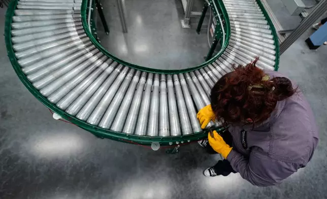 Maintenance technician Liz Cardenas replaces a conveyor belt roller at a training area in a Walmart distribution center Thursday, Sept. 25, 2025, in Bentonville, Ark. (AP Photo/Charlie Riedel)
