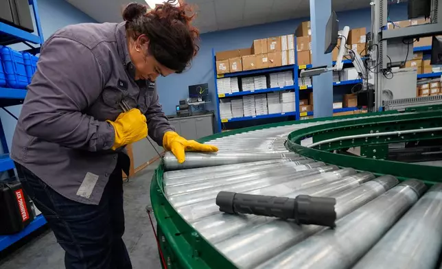 Maintenance technician Liz Cardenas replaces a conveyor belt roller at a training area in a Walmart distribution center Thursday, Sept. 25, 2025, in Bentonville, Ark. (AP Photo/Charlie Riedel)