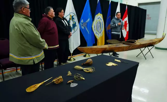 Paul Irngaut, Acting President of Nunavut Tunngavik Inc., left to right, Darrel Nasogaluak, Elder and Chair of Tuktoyaktuk Community Corp., Duane Smith, Chair and CEO of the Inuvialuit Regional Corp., and Natan Obed, President of Inuit Tapiriit Kanatami unveil a traditionally built Inuvialuit kayak and a selection of Inuit items at the Canadian Museum of History in Gatineau, Que., on Tuesday, Dec. 9, 2025. (Sean Kilpatrick /The Canadian Press via AP)