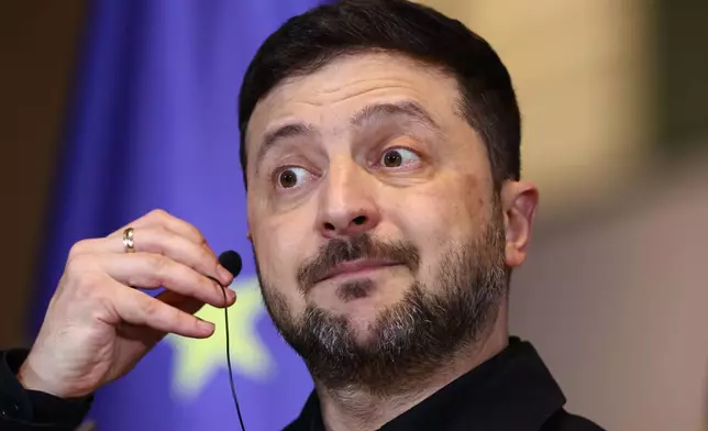 Ukraine's President Volodymyr Zelenskyy reacts during a press conference with German Chancellor Friedrich Merz at the Chancellery in Berlin, Germany, Monday, Dec. 15, 2025. (AP Photo/Maryam Majd)