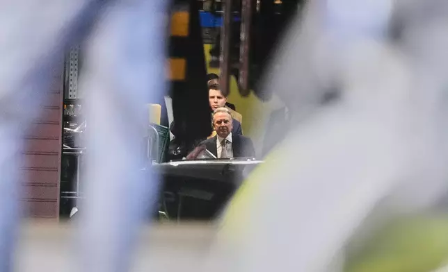 Steve Witkoff, special envoy of the United States, leaves through a hotel garage for talks between representatives of the U.S. and Ukraine in Berlin, Germany, Sunday, Dec. 14, 2025. (AP Photo/Markus Schreiber)