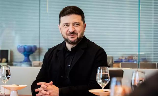 Ukraine's President Volodymyr Zelenskyy smiles during a visit of the German federal parliament, Bundestag, in the Reichstag building in Berlin, Germany, Monday, Dec. 15, 2025. (Christoph Soeder/dpa via AP)