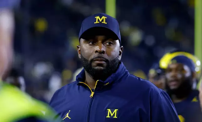 FILE - Michigan coach Sherrone Moore walks off the field following an NCAA football game on Saturday, Aug. 30, 2025, in Ann Arbor, Mich. (AP Photo/Al Goldis, File)