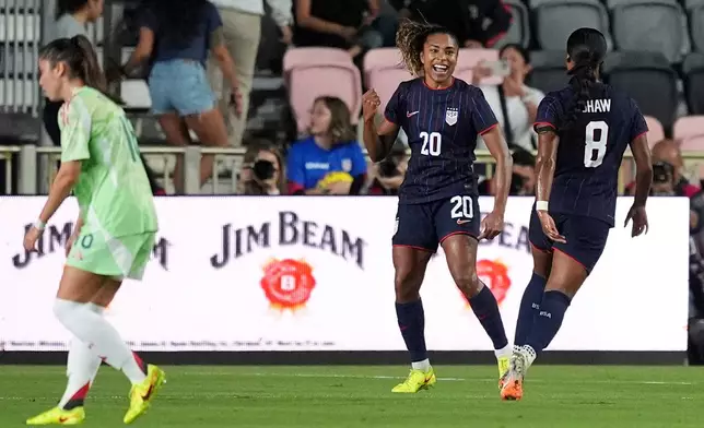 United States forward Catarina Macario (20) celebrates after scoring her side's first goal against Italy during the first half of an international friendly soccer match, Monday, Dec. 1, 2025, in Fort Lauderdale, Fla. (AP Photo/Rebecca Blackwell)