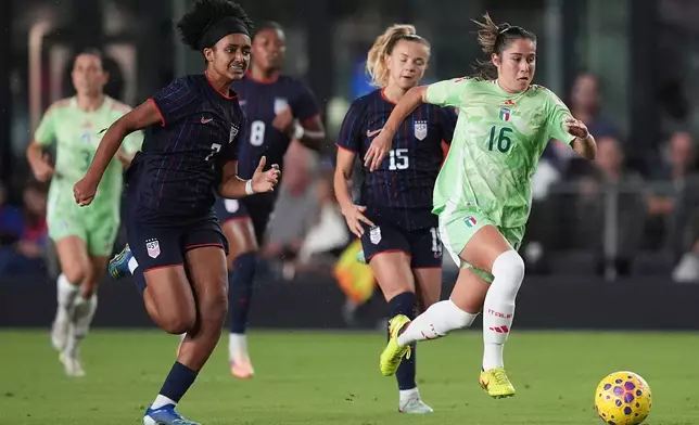Italy midfielder Giulia Dragoni (16) drives forward as United States midfielder Lily Yohannes (7) pursues during the first half of an international friendly soccer match, Monday, Dec. 1, 2025, in Fort Lauderdale, Fla. (AP Photo/Rebecca Blackwell)