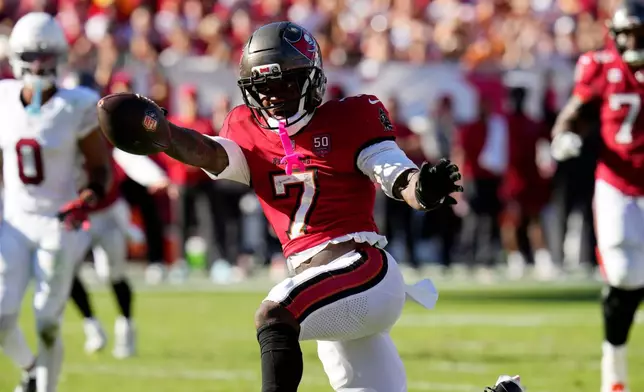 Tampa Bay Buccaneers running back Bucky Irving (7) celebrates a touchdown run as Will Johnson (0) looks on during the second half of an NFL football game Sunday, Nov. 30, 2025, in Tampa, Fla. (AP Photo/Chris O'Meara)