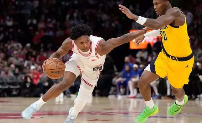 Houston Rockets guard Amen Thompson (1) controls the ball against Indiana Pacers guard Bennedict Mathurin (00) during the first half of an NBA basketball game Monday, Dec. 29, 2025, in Houston. (AP Photo/Karen Warren)