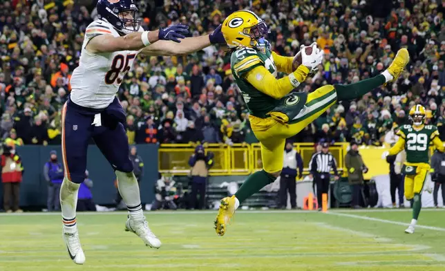 Green Bay Packers cornerback Keisean Nixon (25) intercepts a pass against Chicago Bears tight end Cole Kmet (85) during the second half of an NFL football game Sunday, Dec. 7, 2025, in Green Bay, Wis. (AP Photo/Matt Ludtke)