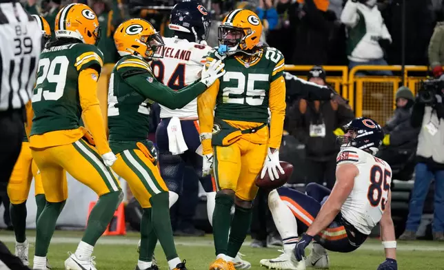 Green Bay Packers cornerback Keisean Nixon (25) celebrates after an interception against Chicago Bears tight end Cole Kmet (85) during the second half of an NFL football game Sunday, Dec. 7, 2025, in Green Bay, Wis. (AP Photo/Morry Gash)