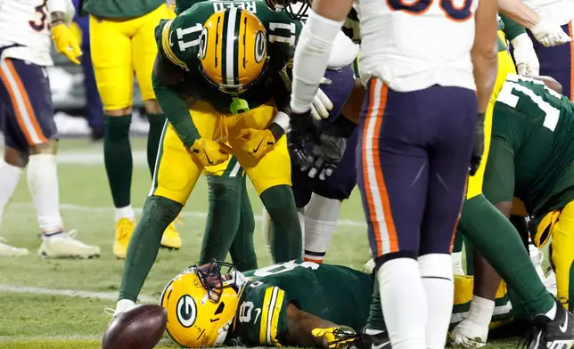 Green Bay Packers running back Josh Jacobs (8) celebrates with wide receiver Jayden Reed (11) after scoring a touchdown against the Chicago Bears during the second half of an NFL football game Sunday, Dec. 7, 2025, in Green Bay, Wis. (AP Photo/Mike Roemer)