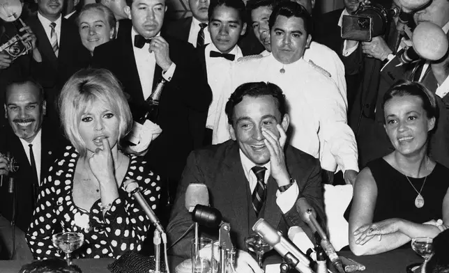 FILE - French Actress Brigitte Bardot, left, attends a news conference in Mexico City, Jan. 18, 1965. Seated next to her is producer Louis Malle and at right is French actress Jeanne Moreau. (AP Photo/File)
