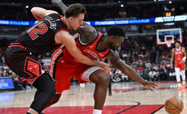 New Orleans Pelicans' Zion Williamson, right, battles Chicago Bulls' Zach Collins (12) for the ball during the first half of an NBA basketball game Sunday, Dec. 14, 2025, in Chicago. (AP Photo/Paul Beaty)