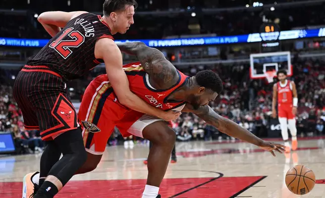 New Orleans Pelicans' Zion Williamson, right, battles Chicago Bulls' Zach Collins (12) for the ball during the first half of an NBA basketball game Sunday, Dec. 14, 2025, in Chicago. (AP Photo/Paul Beaty)