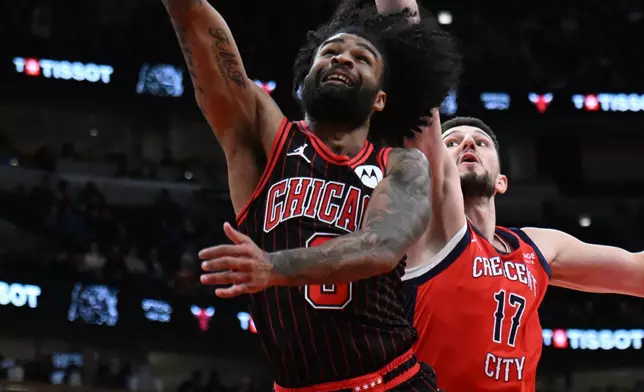 Chicago Bulls' Coby White (0) goes up to shoot against New Orleans Pelicans' Karlo Matkovic (17) during the second half of an NBA basketball game Sunday, Dec. 14, 2025, in Chicago. (AP Photo/Paul Beaty)