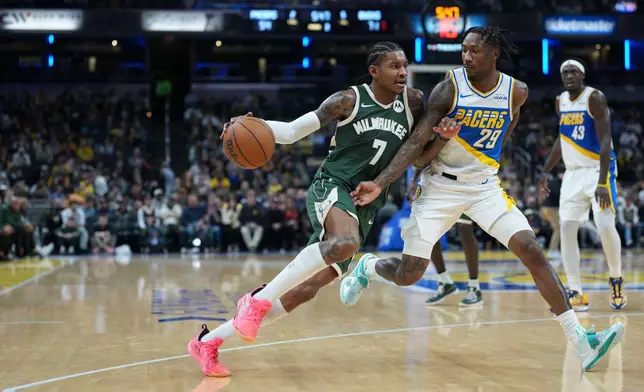 Milwaukee Bucks guard Kevin Porter Jr. (7) moves around Indiana Pacers guard Quenton Jackson (29) during the second half of an NBA basketball game in Indianapolis, Tuesday, Dec. 23, 2025. (AP Photo/AJ Mast)