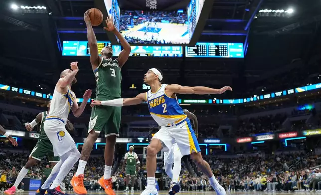 Milwaukee Bucks center Myles Turner (3) shoots over Indiana Pacers guard Andrew Nembhard (2) during the second half of an NBA basketball game in Indianapolis, Tuesday, Dec. 23, 2025. (AP Photo/AJ Mast)