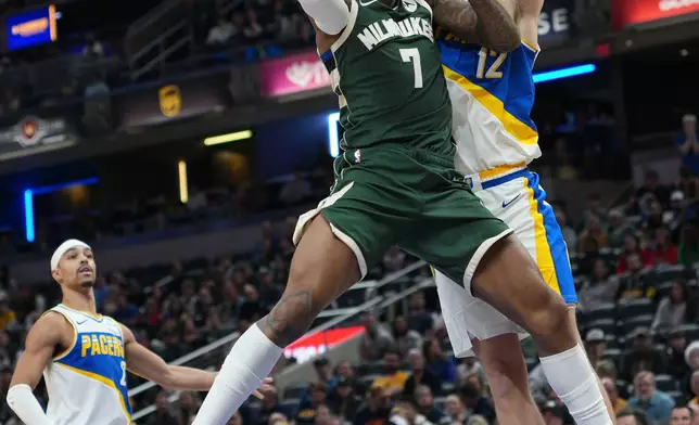 Milwaukee Bucks guard Kevin Porter Jr. (7) shoots in front of Indiana Pacers guard Johnny Furphy (12) during the second half of an NBA basketball game in Indianapolis, Tuesday, Dec. 23, 2025. (AP Photo/AJ Mast)