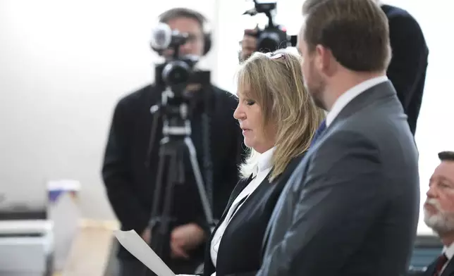 Former Colleton County Clerk of Court Mary Rebecca "Becky" Hill reads a statement as she pleads guilty on Monday, Dec. 8, 2025, in St. Matthews, S.C.. (AP Photo/Jeffrey Collins)