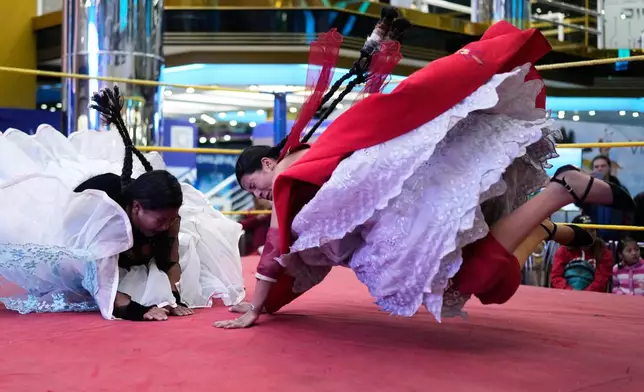 Wrestlers perform during a ticketed wrestling show in El Alto, Bolivia, Saturday, May 3, 2025. (AP Photo/Juan Karita)
