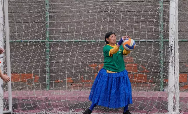 FILE - Herberta Pucho, of the Las Kantutitas team, makes a save during a handball tournament for grandmothers in El Alto, Bolivia, Dec. 9, 2025. (AP Photo/Juan Karita, File)